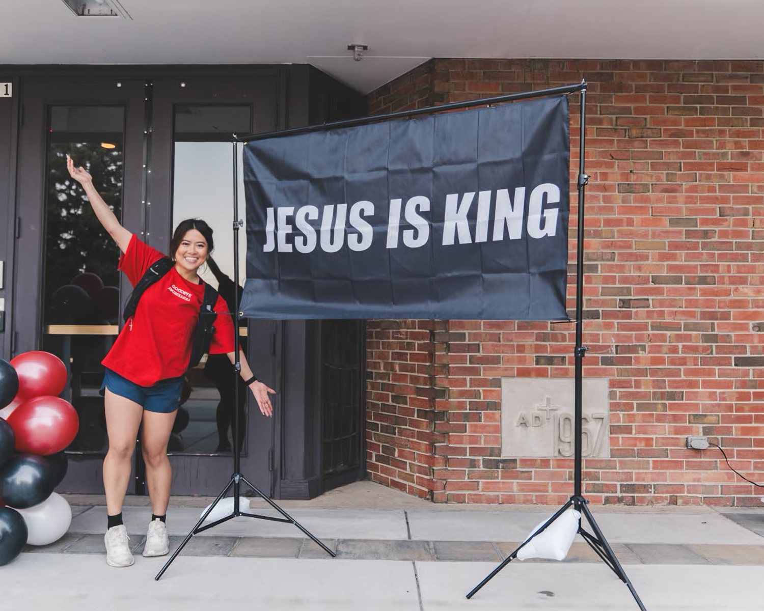 A Jesus Is King banner at the entrance of an RWC Denver event